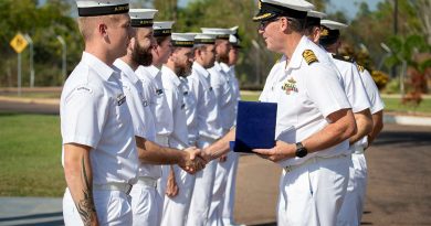 Captain Simon Cannell presents a challenge coin to Leading Seaman Grady Munks during a homeporting ceremony at Larrakeyah Defence Precinct, Darwin, NT. Photos by Petty Officer Leo Baumgartner.