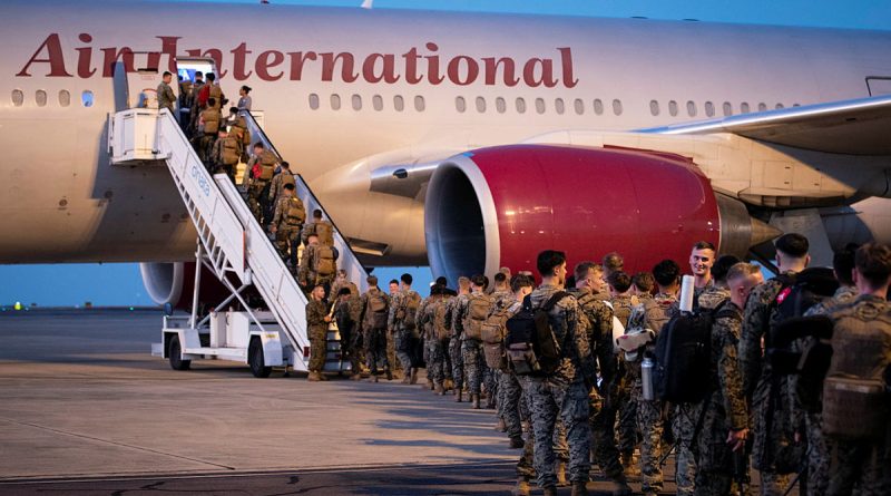 United States marines board an Omni Air International flight departing from RAAF Base Darwin, NT. Photo by Petty Officer Leo Baumgartner.