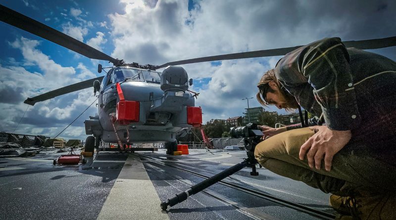 Training Force Multimedia Unit technical multimedia specialist Chris Paraskevas films an MH-60R Seahawk aboard a Canberra-class landing helicopter dock. Story by Richard Wilkins.