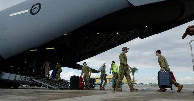 RAAF personnel assist Australian citizens and their families into a C-17A Globemaster III at Ben Gurion airport in Israel. Photos by Corporal Robert Whitmore.