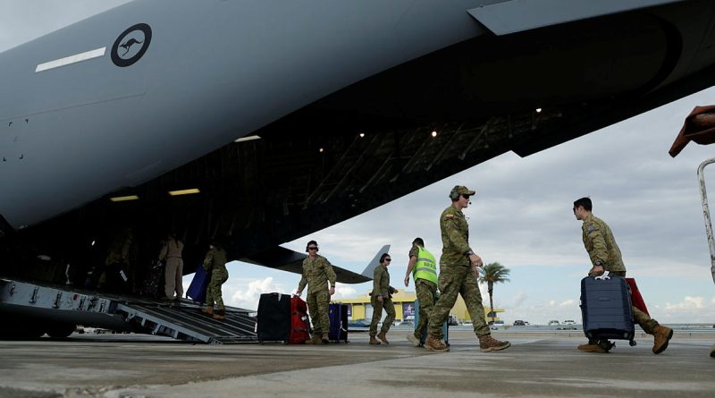RAAF personnel assist Australian citizens and their families into a C-17A Globemaster III at Ben Gurion airport in Israel. Photos by Corporal Robert Whitmore.