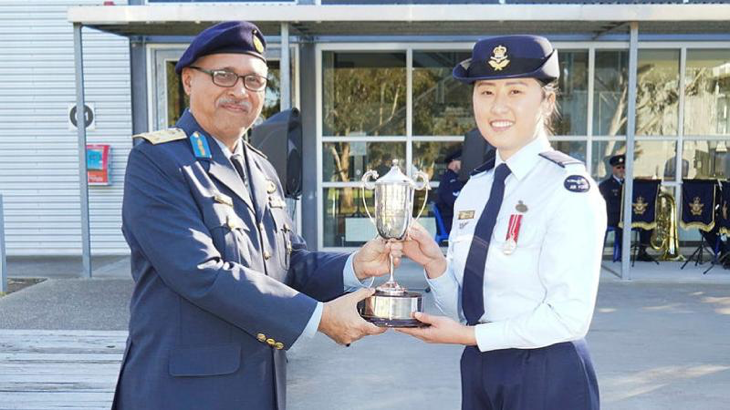 RMAF Brigadier Ben Khedda presents the Gary Haynes trophy to Pilot Officer Pearl Jeong, at RAAF Base East Sale. Story by Flying Officer Rowan Crinall. Photo by Flight Lieutenant Daina Sawade.