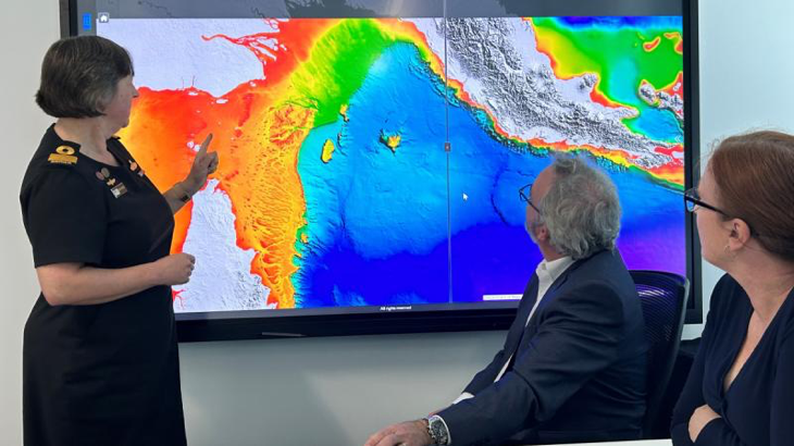 Hydrographer of Australia Commodore Robyn Phillips, Australian Hydrographic Office (AHO) Director Maritime Data Management Doug White and AHO Director Maritime Relationships and Governance Nat McLean use the Australian Bathymetric and Topography Grid. Story by Elizabeth de Bol.
