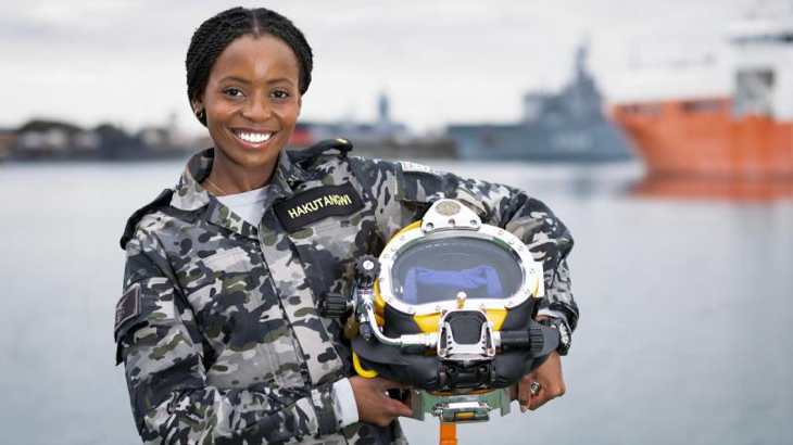 Gap Year Seaman Vimbayi Hakutangwi with a dive helmet at HMAS Stirling, Western Australia. Story by Richard Wilkins. Photo by Able Seaman Rikki-Lea Phillips.