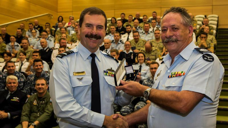 Then Chief of Air Force Air Marshal Leo Davies, left, presents Warrant Officer Wayne Newman with his second clasp to the Federation Star for 45 years’ service in the RAAF in 2016. Story by Corporal Madhur Chitnis. Photo by Corporal David Cotton.