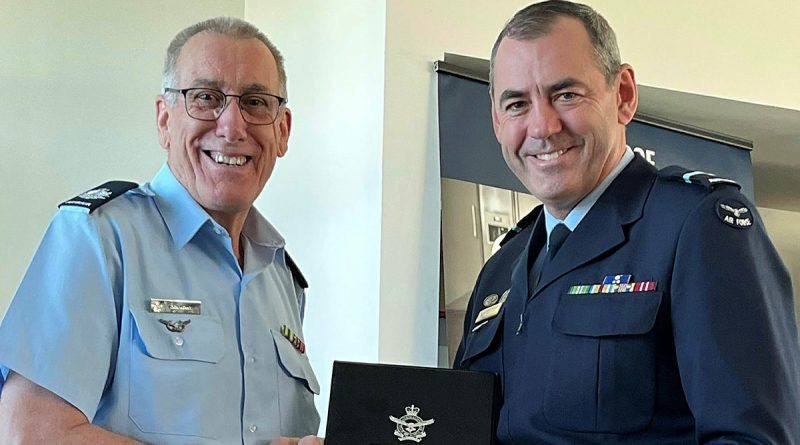 Warrant Officer Don Kenny, left, is presented with his Defence Long Service Medal, sixth bar (2nd Federation Star), by Chief of Staff Air Force Headquarters Air Commodore James Badgery. Story by Flight Lieutenant Nick O’Connor.