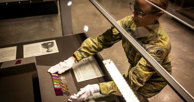 Corporal Stacey Kitcher from Army History Unit places a Victoria Cross and medal set into the display case at the Australian Army Infantry Museum, Singleton. Story and photos by Corporal Melina Young.