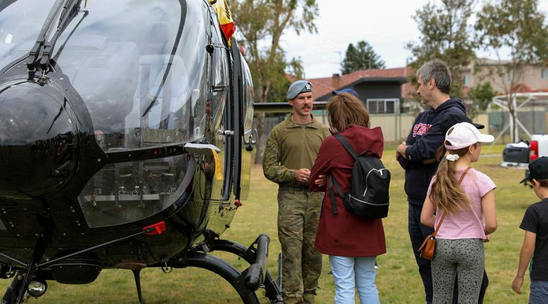 An officer from Australian Army 16th Aviation Brigade speaks to visitors about the EC-135 at the Randwick Barracks Open Day. Story by Captain Katy Manning. Photos by Private Sarah Fisher.