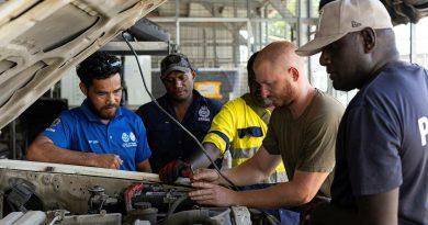 Australian soldier Craftsman Bradley Scheef and members of the Royal Solomon Islands Police Force (RSIPF) maintain a police vehicle in preparation for the Pacific Games. Story by Major Roger Brennan. Photos by Leading Seaman Jarrod Mulvihill.