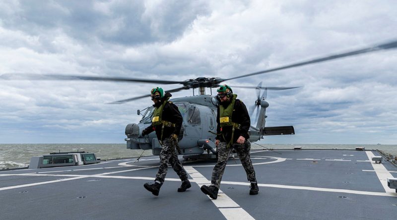 Leading Seaman Kalani Brinkmeier (left) and Able Seaman Samuel Speakman from HMAS Toowoomba on the flight deck during flying operation as part of Operation Argos. Photo by Leading Seaman Ernesto Sanchez.