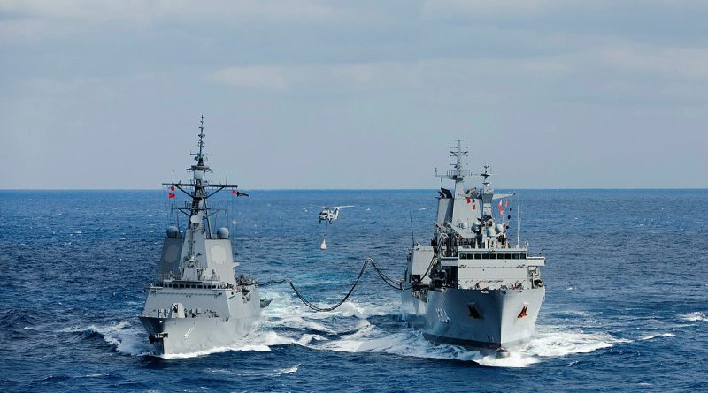 HMAS Stalwart’s embarked MH-60R helicopter ‘Boomerang’ conducts a vertical replenishment while the ship conducts a replenishment at sea with HMAS Brisbane. Story by Lieutenant Max Logan. Photos by Leading Seaman Daniel Goodman.