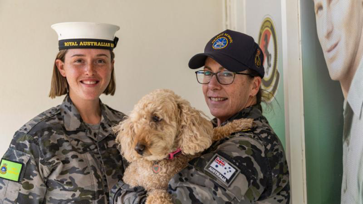 Recruit Cassandra Kelly, left, and Recruit School Petty Officer Deborah Barthelson with her dog, Molly Grace, at HMAS Cerberus Recruit School, Melbourne. Story by Lieutenant Jessica Craig. Photo by Able Seaman Jasmine Moody.