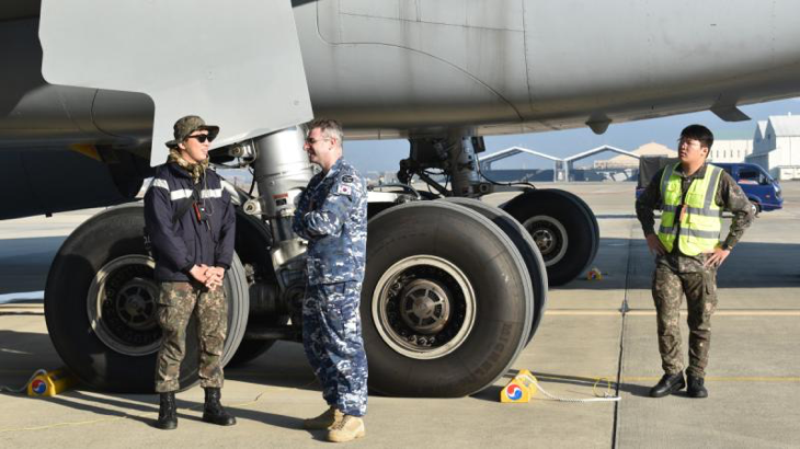 Leading Aircraftman Zachary Delaney (second from left), a RAAF linguist speaks to a Republic of Korea Air Force member on the flightline at Gimhae Air Base, in South Korea. Story by Flight Lieutenant Steffi Blavius.