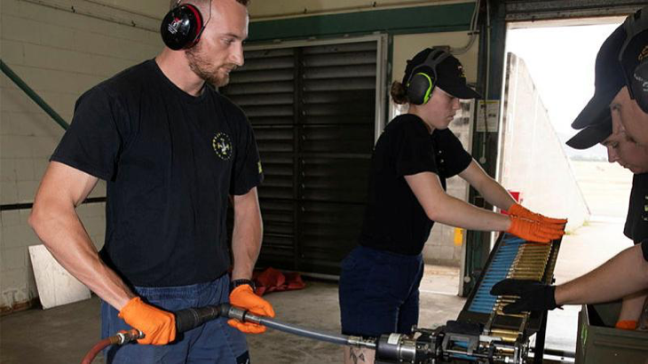 Armament fitters from 1 Squadron, Leading Aircraftman Ethan Collingwood, left, and Aircraftwoman Hunter Glover, loading rounds into an ammunition loader at the bomb preparation area at RAAF Base Townsville during Exercise Black Dagger. Story by Flight Lieutenant Gerard Reed. Photo by Corporal Brett Sheriff.