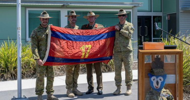 From left, Officer Commanding 17th Construction Squadron Major Lincoln Barbare, flag orderly Sapper Jack Miles, Major General Stephen Day and Squadron Sergeant Major 17th Construction Squadron Warrant Officer Class Two Taj Whelan with the returned flag at RAAF Base Amberley, Queensland. Story by Captain Evita Ryan. Photo by Warrant Officer Class Two Kim Allen.