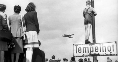 Berlin civilians watch an airlift plane land at Templehof Airport, 1948. United States Air Force Historical Research Agency photo, via Wikipedia.