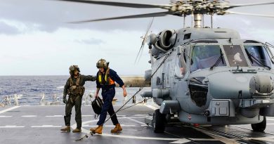 Leading Seaman Matthew Parry escorts Liam Glackin from HMAS Brisbane’s embarked MH-60R helicopter while conducting an evacuation from Willis Island off the coast of Queensland. Story by Lieutenant Commander Andrew Herring.