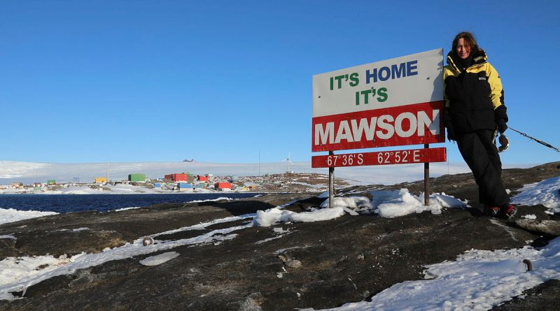 Squadron Leader Catherine Humphries with the "It's Home It's Mawson" sign at the research station. Story by Corporal Veronica O’Hara.