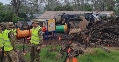 Aussie soldiers plan their cleanup work at the Oxenford State School where large trees fell during Christmas-holiday storms and needed to be removed. Photo by Sergeant Hatcher.
