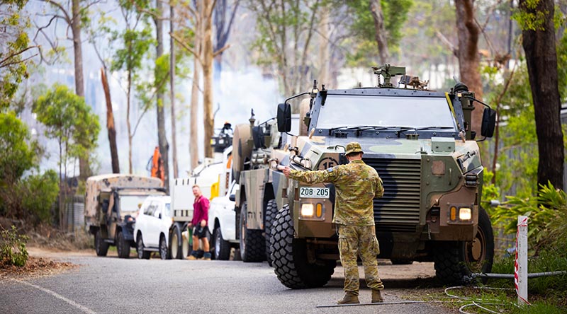 Australian Army soldiers and high -clearance vehicles from 11th Brigade assist in the cleanup at Coomera, following recent violent storms. Photographer unknown.