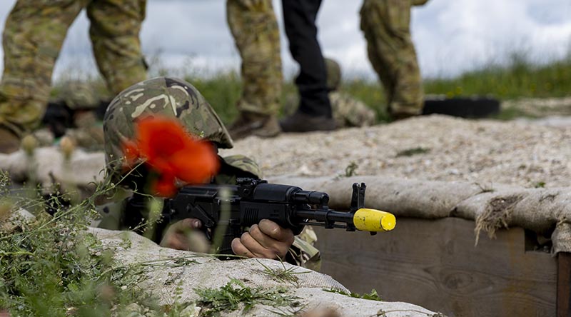 An Armed Forces of Ukraine recruit scans for enemy during trench defence training, as part of Operation Kudu in the United Kingdom. Photo by Leading Aircraftwoman Emma Schwenke.