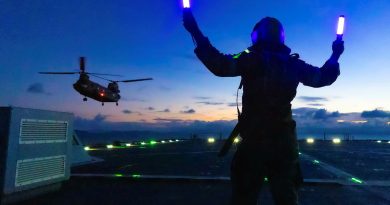 Leading Seaman Michael Mason marshals an Army CH-47 Chinook on board HMAS Choules during aviation training off the coast of Townsville, Queensland. Photo by Able Seaman Jasmine Saunders.