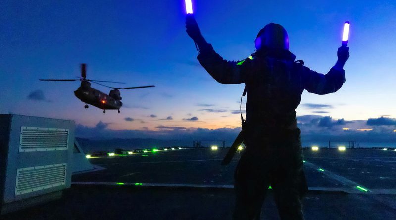 Leading Seaman Michael Mason marshals an Army CH-47 Chinook on board HMAS Choules during aviation training off the coast of Townsville, Queensland. Photo by Able Seaman Jasmine Saunders.