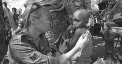Australian Army Medic, then Sergeant Joanne Cook, examines a little girl with malaria in February 1993. Story by Corporal Luke Bellman. Photo by Corporal Gary Ramage.