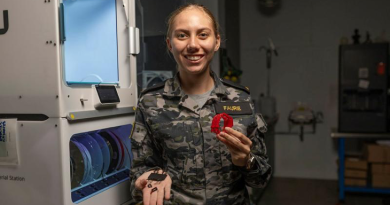 Seaman Elmarie Faurie in the Navy' Centre for Innovation, Sydney, with her 3D-printed torch clip. Photo by Able Seaman Lucinda Allanson.