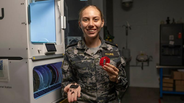 Seaman Elmarie Faurie in the Navy' Centre for Innovation, Sydney, with her 3D-printed torch clip. Photo by Able Seaman Lucinda Allanson.