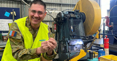 Captain Andre Borg with a new field ration eating device (FRED) at the manufacturing workshop in Queensland. Story by Corporal Michael Rogers.
