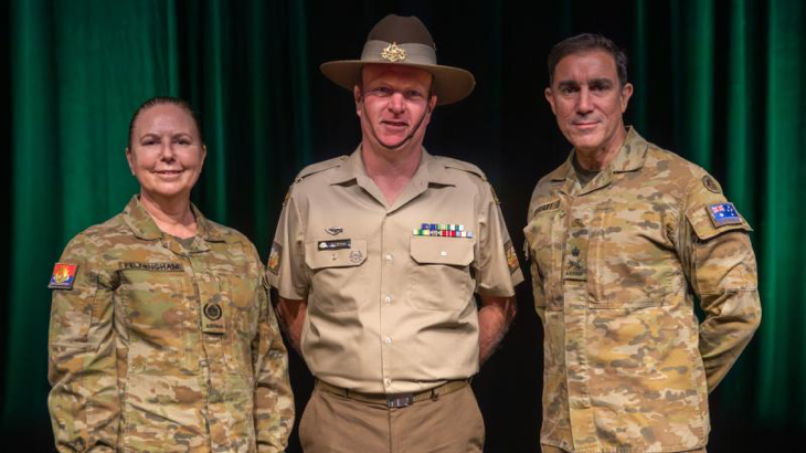 Chief of Army Lieutenant General Simon Stuart, right, and Regimental Sergeant Major of Army Warrant Officer Kim Felmingham, left, present Warrant Officer First Class Andrew Beaman with his advancement to Tier-C. Story and photo by Corporal Michael Rogers.