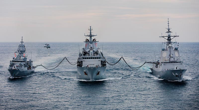 HMAS Stalwart conducts a dual replenishment at sea with HMA Ships Toowoomba and Brisbane during an Asian regional presence deployment. Photo by Leading Seaman Daniel Goodman.
