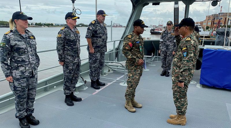 Timor-Leste Defence Force Lieutenant Jacinto Do Nascimento salutes Lieutenant Clementino Colo ahead of his promotion on board PT Paluma. Story by Richard Wilkins.