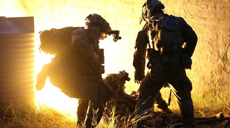 A 3rd Combat Engineer Regiment soldier assists a simulated casualty during an urban breaching exercise at Townsville Field Training Area. Story and photo by Corporal Luke Bellman.