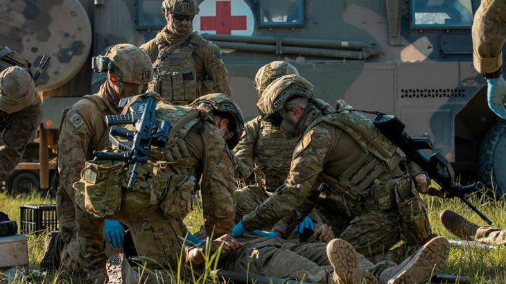 Medics from 2nd Health Brigade simulate rendering first aid to a soldier during a mass casualty exercise in Shoalwater Bay training area, Queensland, in 2023. Story by Captains Prashanth Shanmugan and Nicholas Marquis. Photo by Corporal Nicole Dorrett.