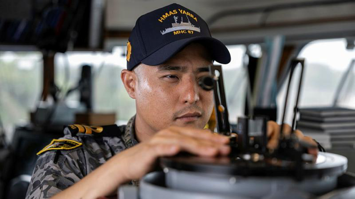 Lieutenant Yoon Lee takes a bearing on the bridge of HMAS Yarra. Story by Lieutenant Geoff Long. Photo by Leading Seaman Jarrod Mulvihill.