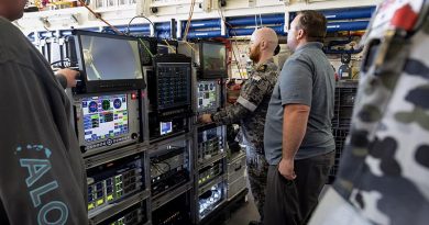 US Missile Defence Agency member Steven Foster shows Royal Australian Navy Petty Officer Thomas Dann how to control detection equipment in the Hanger of HMAS Stuart during a missile-detection test off Hawaii. Photo by Leading Seaman Rikki-Lea Phillips.