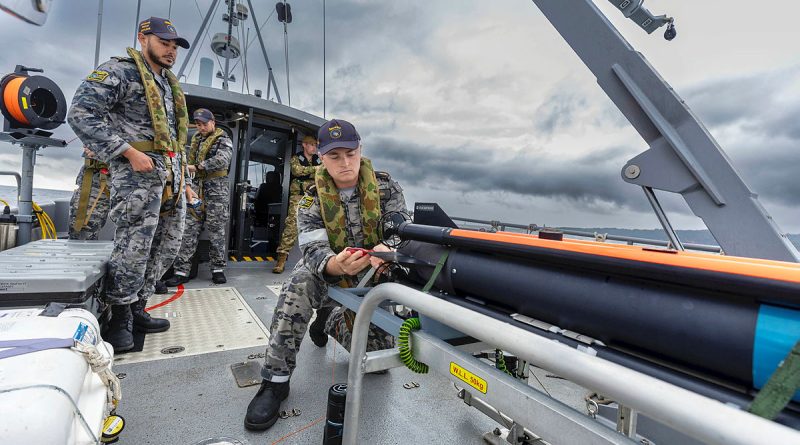 Able Seaman Grayden Ash inspects the SeaFox expendable mine neutralisation system onboard a mine countermeasure support boat during Exercise Dugong 24. Story by Corporal Michael Rogers. Photo by Leading Seaman Sittichai Sakonpoonpol.