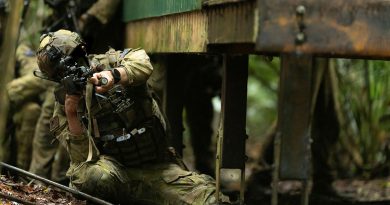 An Australian Army soldier from the 8th/9th Battalion, the Royal Australian Regiment, helps clear a village during Exercise Regional Warfighter in Tully, Queensland. Story by Captain Cody Tsaousis. Photos by Private Alfred Stauder.