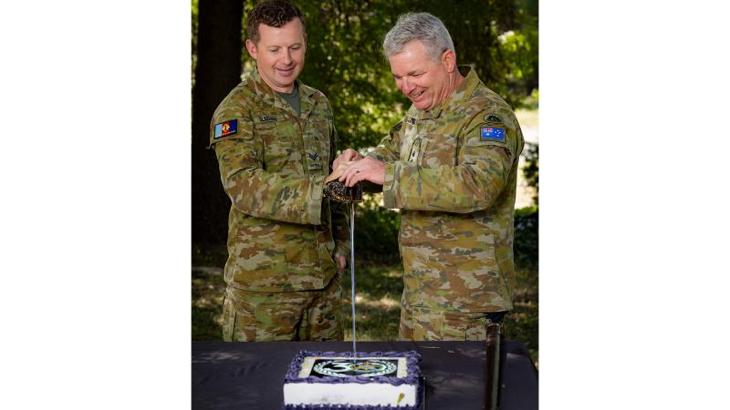 Australian Army Public Relations Service's Corporal Andrew Sleeman and Head of Corps Colonel Jason Logue cut the birthday cake at 1st Joint Public Affairs Unit, Canberra, in celebration of the corps' 30th birthday. Story by Major Lily Mulholland. Photo by Corporal Lisa Sherman.