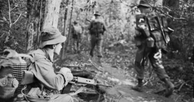 Vietnam. 1966-11-28. Private Ken Wallace of Mitchelton, Brisbane, Qld, keeps a sharp watch as his mates in the 6th Battalion, The Royal Australian Regiment (6RAR), advance along a jungle track during Operation Ingham. Australian War Memorial file number CUN/66/0932/VN