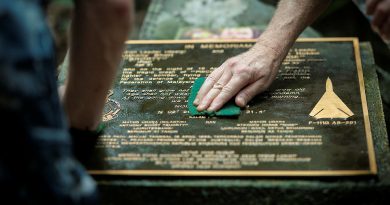 Royal Australian Air Force Wing Commander David Riddel and Mark Johnson clean the memorial plaque at the crash site of F-111G A8-291, in Pulau Aur, Malaysia. Story. y Flight Lieutenant Rob Hodgson. Photos by Leading Aircraftman Kurt Lewis.