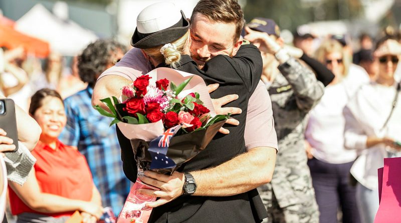 Lieutenant Rene Van Rooyen from HMAS Warramunga embraces her partner on the wharf of Fleet Base East, Sydney, on return from deployment.  Story by Lieutenant Nicole Gallie. Photo by Able Seaman Lucinda Allanson.