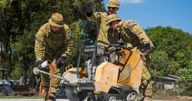 Air Force's Corporal Anthony Holmes, left, Leading Aircraftman Matthew Park and Leading Aircraftman Ryan Wilson operate a concrete-cutting saw at Basa Air Base, Philippines, during Exercise Balikatan. Story by Sergeant David Said. Photos by Corporal Sam Price.