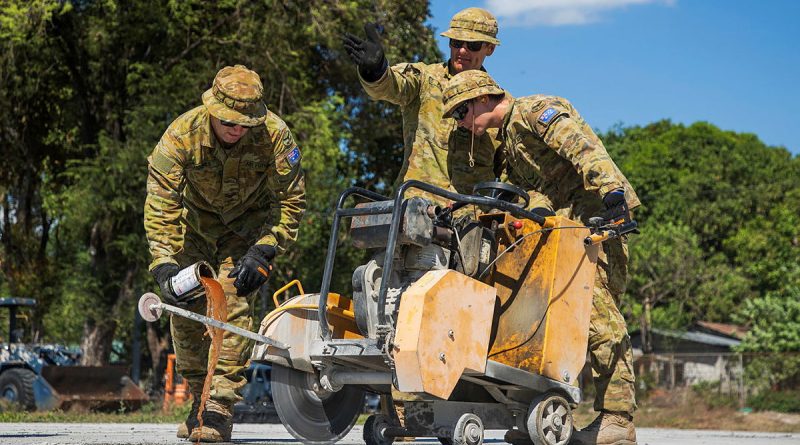 Air Force's Corporal Anthony Holmes, left, Leading Aircraftman Matthew Park and Leading Aircraftman Ryan Wilson operate a concrete-cutting saw at Basa Air Base, Philippines, during Exercise Balikatan. Story by Sergeant David Said. Photos by Corporal Sam Price.