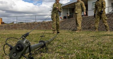 Private Chen Shi raises a communications mast off the ground during Exercise Arras Sprint. Photos by Private Peter Mosley.