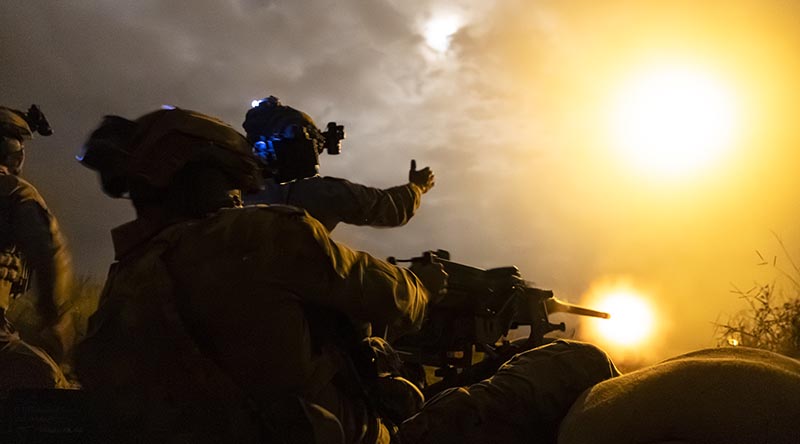 Australian Army soldiers from 1st Battalion, Royal Australian Regiment, fire a 12.7mm Mark 2 machine gun at night at Townsville Field Training Area, Queensland. Photo by Corporal Brandon Grey and Captain Brittany Evans.
