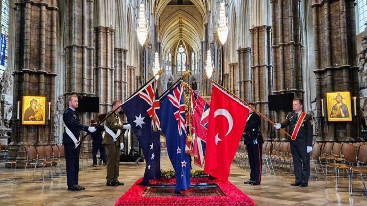 The flags of Australia, New Zealand, the United Kingdom and Turkiye are held over the grave of the Unknown Warrior in Westminster Abbey following the conclusion of the Anzac Day memorial service. Story and photo by Lieutenant Commander John Thompson.