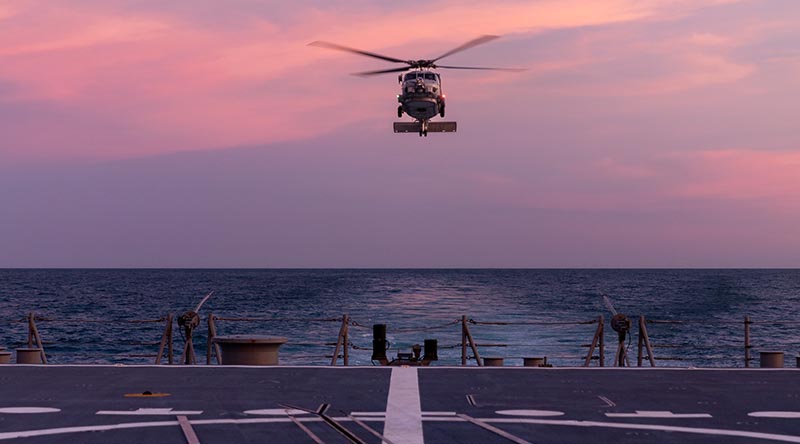 HMAS Hobart’s embarked MH-60R helicopter “Voodoo” returns to the ship during flying operations on her current deployment. Photo by Leading Seaman Matthew Lyall.